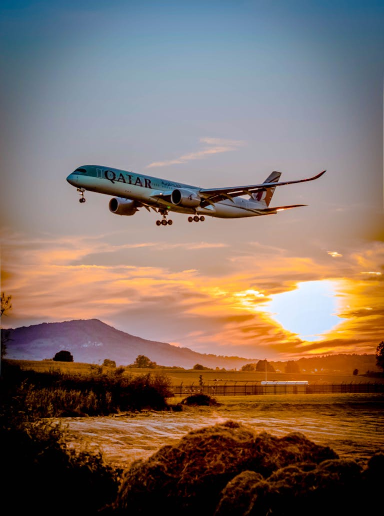 A passenger airplane flying over a scenic landscape at sunset, capturing the aviation spirit.